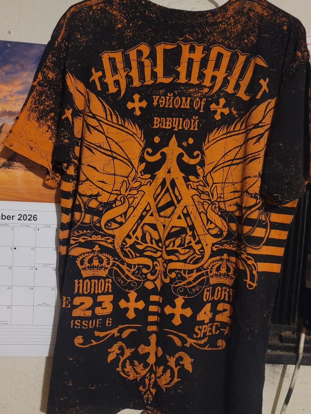 Archaic Black Tee with Bold Orange Winged Crest